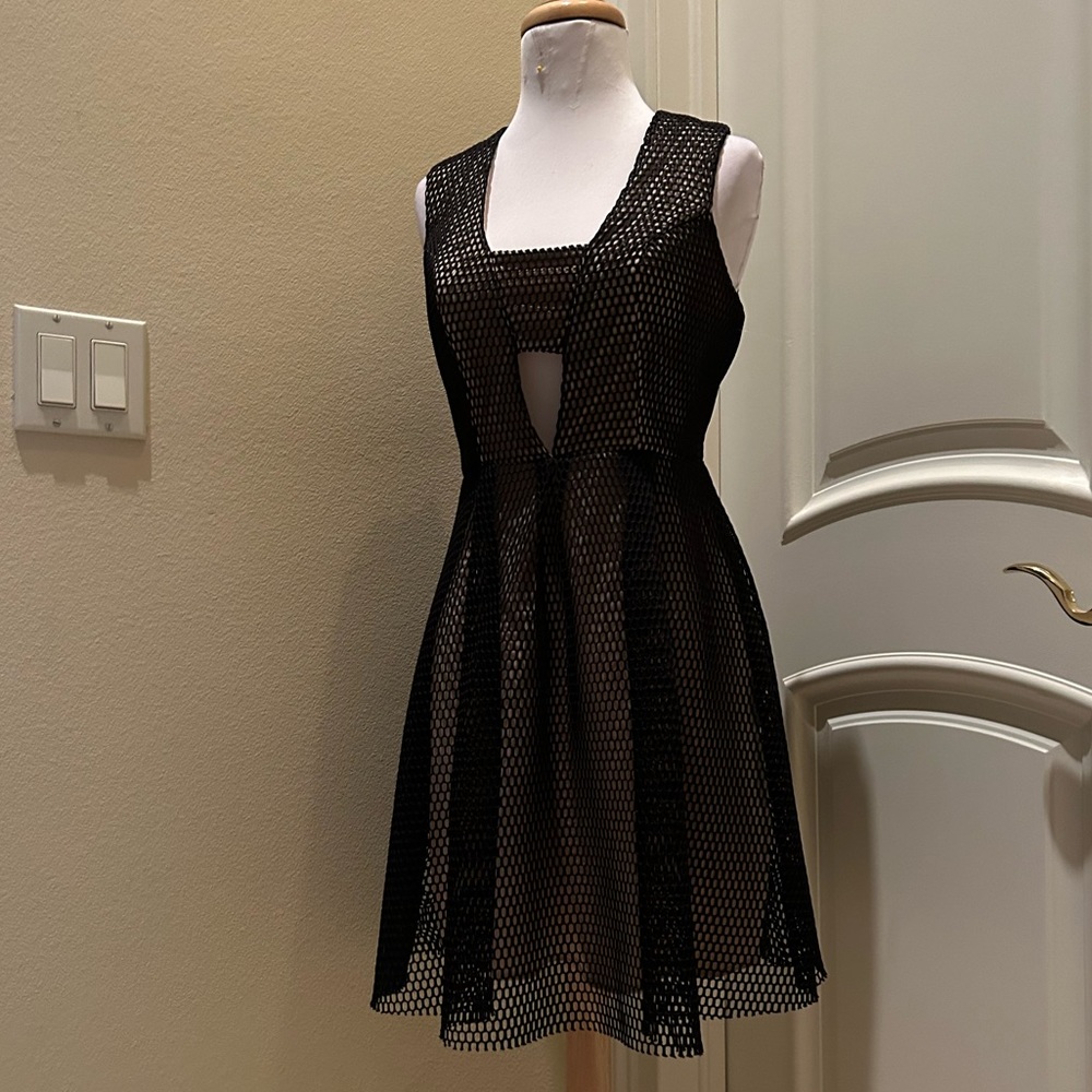 Black open back mesh fabric skater style dress with nude lining